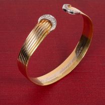 A tri-colour 18ct gold bangle