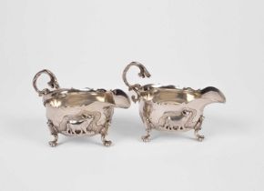 A pair of unusual silver sauce boats