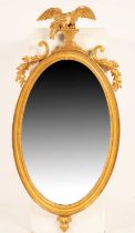 A Regency oval giltwood mirror