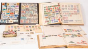 Four stamp albums and some loose stamps