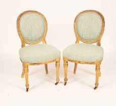 A pair of gilt framed side chairs