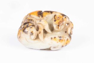 A Chinese pebble jade carving of entwined beasts