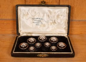 A boxed set of Indian silver buttons