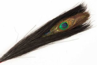 A Chinese double-eyed peacock feather for court official's winter court hat