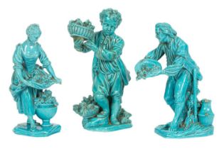 A pair of Minton turquoise glazed figures of gardeners