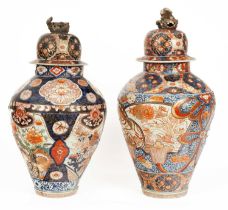 Two Japanese Imari large baluster vases with domed covers