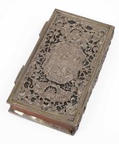 A white metal cased copy of The Book of Common Prayer