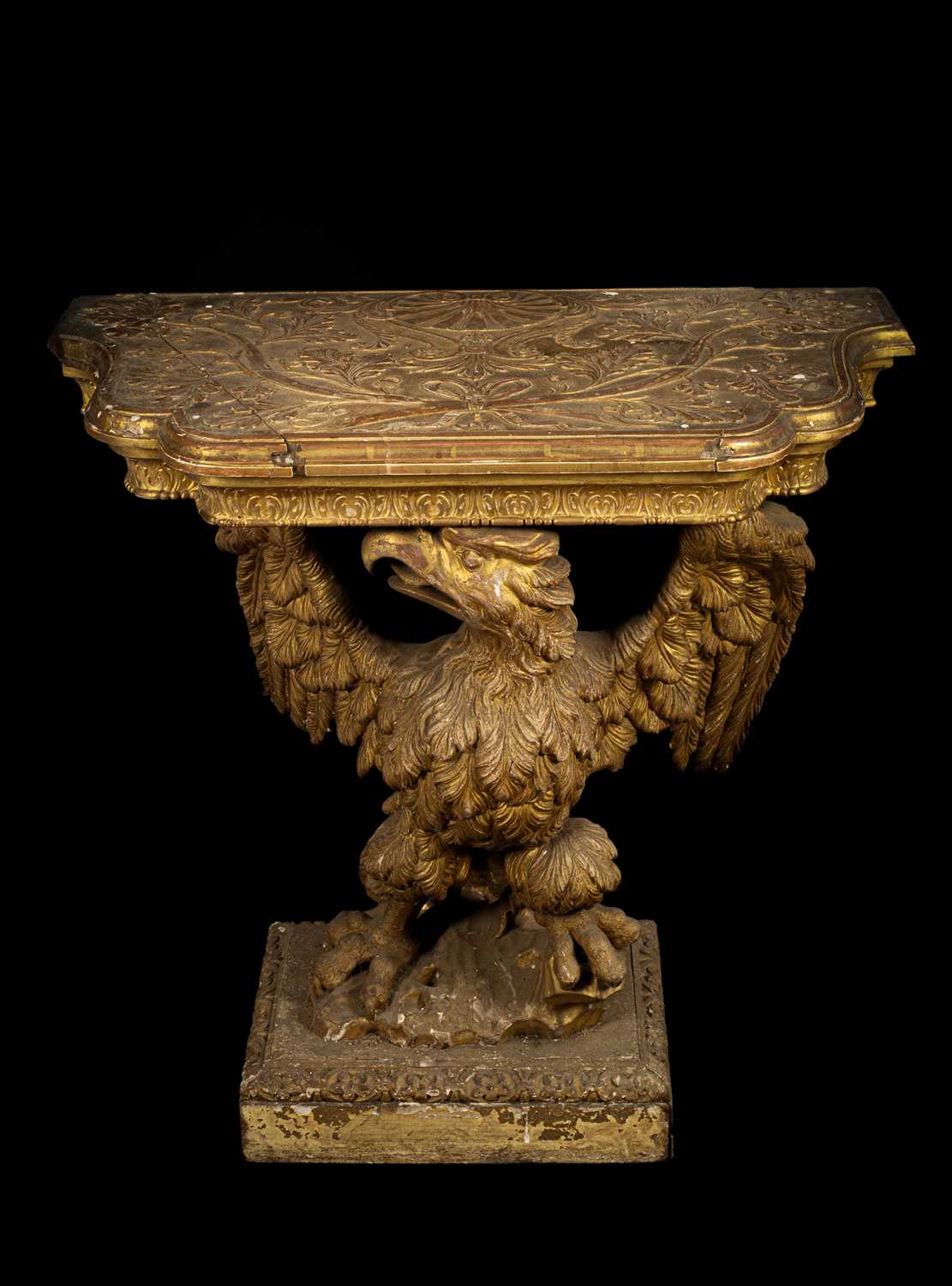 A George II gilt gesso serpentine eagle console table