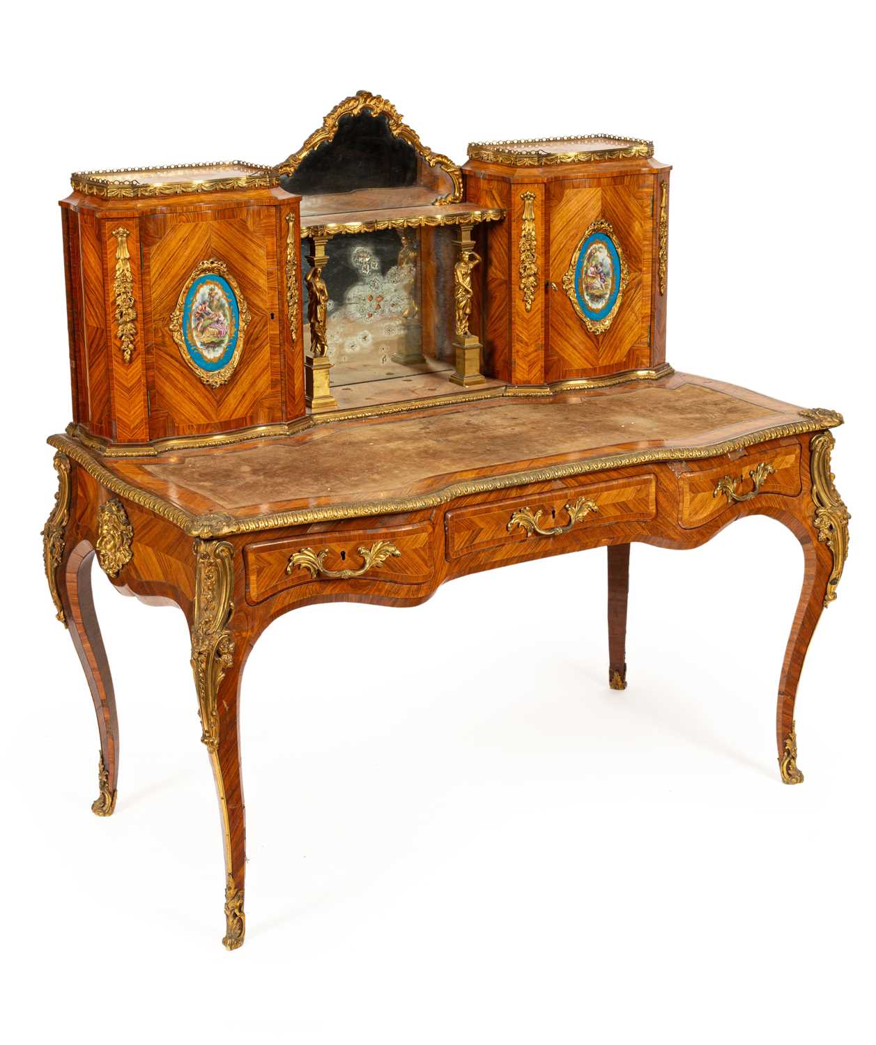 A Victorian ormolu mounted tulipwood and kingwood desk in the Louis XV style