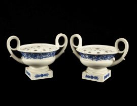 A pair of Wedgwood white stoneware potpourri vases and pierced covers