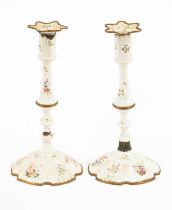 A pair of South Staffordshire white enamel candlesticks