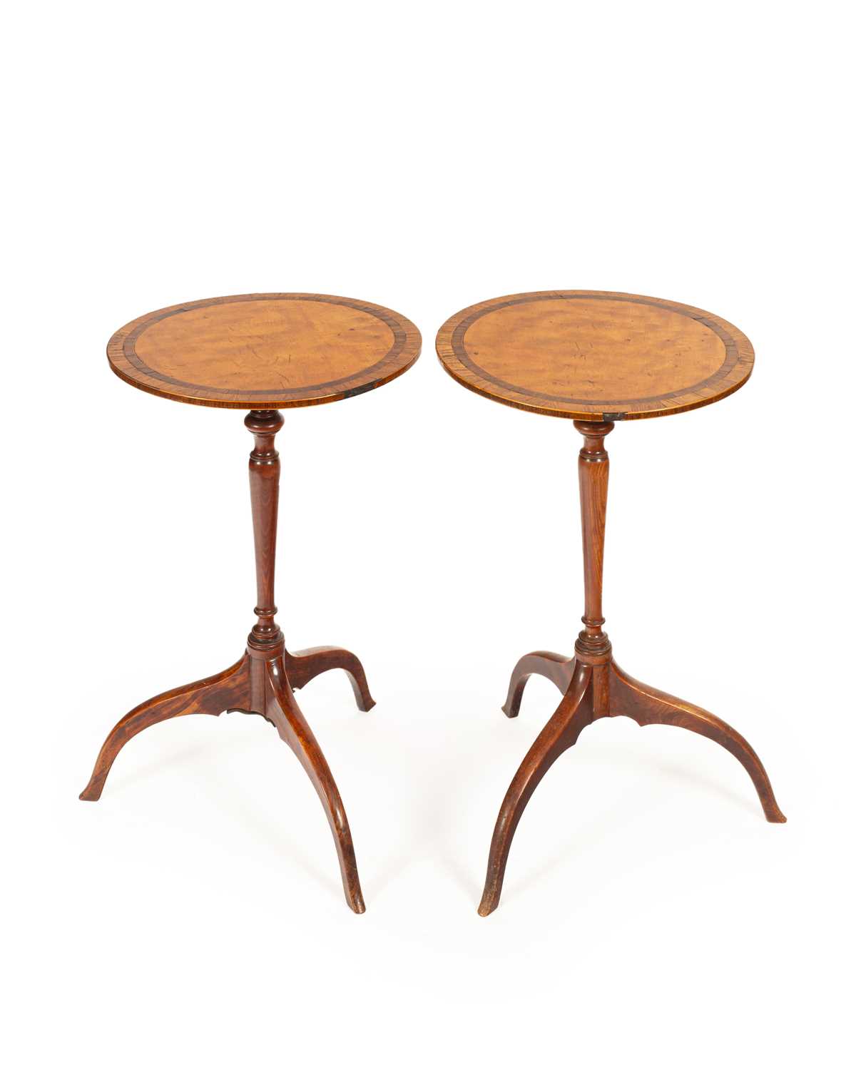 A pair of late George III satinwood tripod tables