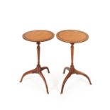 A pair of late George III satinwood tripod tables