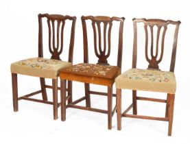 Three George III country made stained elm dining chairs