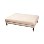 A large cream upholstered footstool