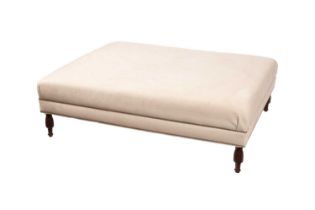 A large cream upholstered footstool