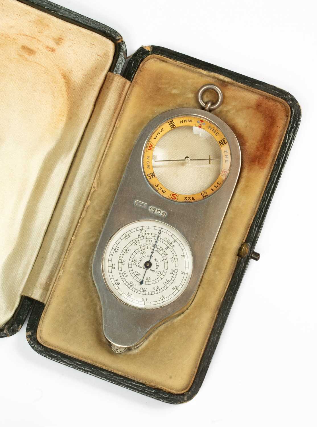 A silver compass and map distance measurer