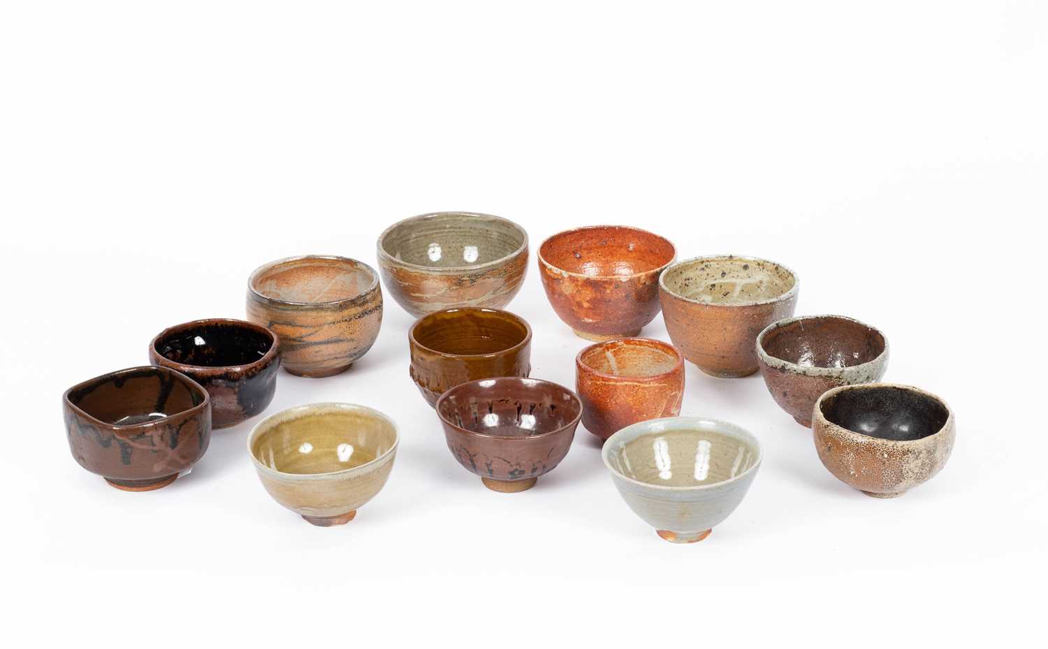 Thirteen assorted studio pottery tea bowls and bowls