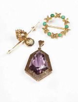 A gold and amethyst set pendant