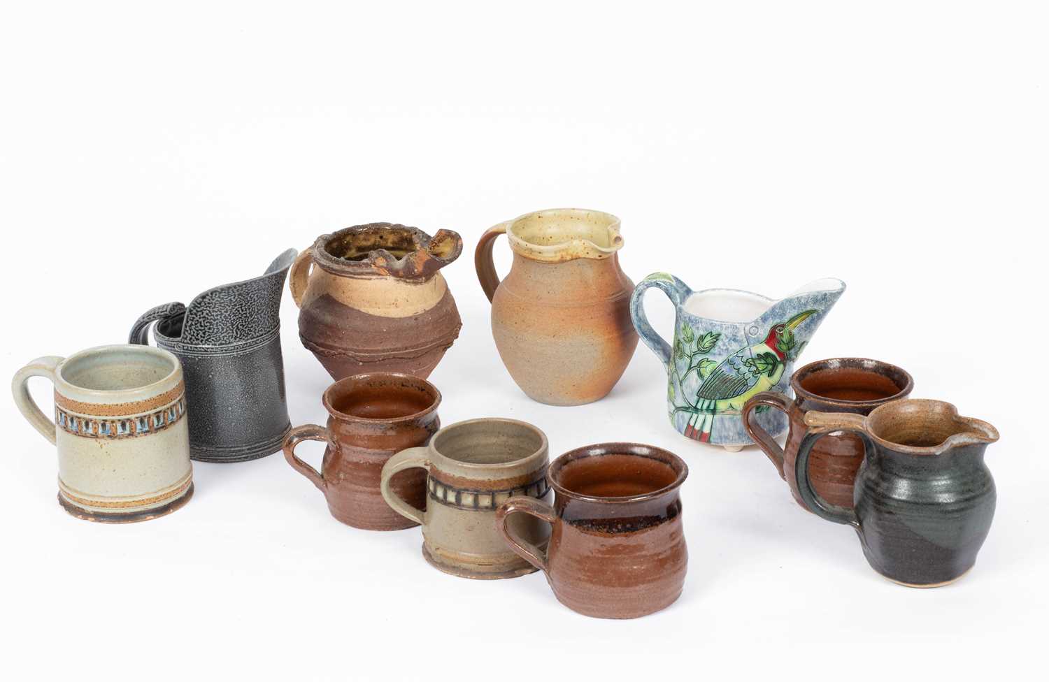 Various studio pottery jugs and mugs