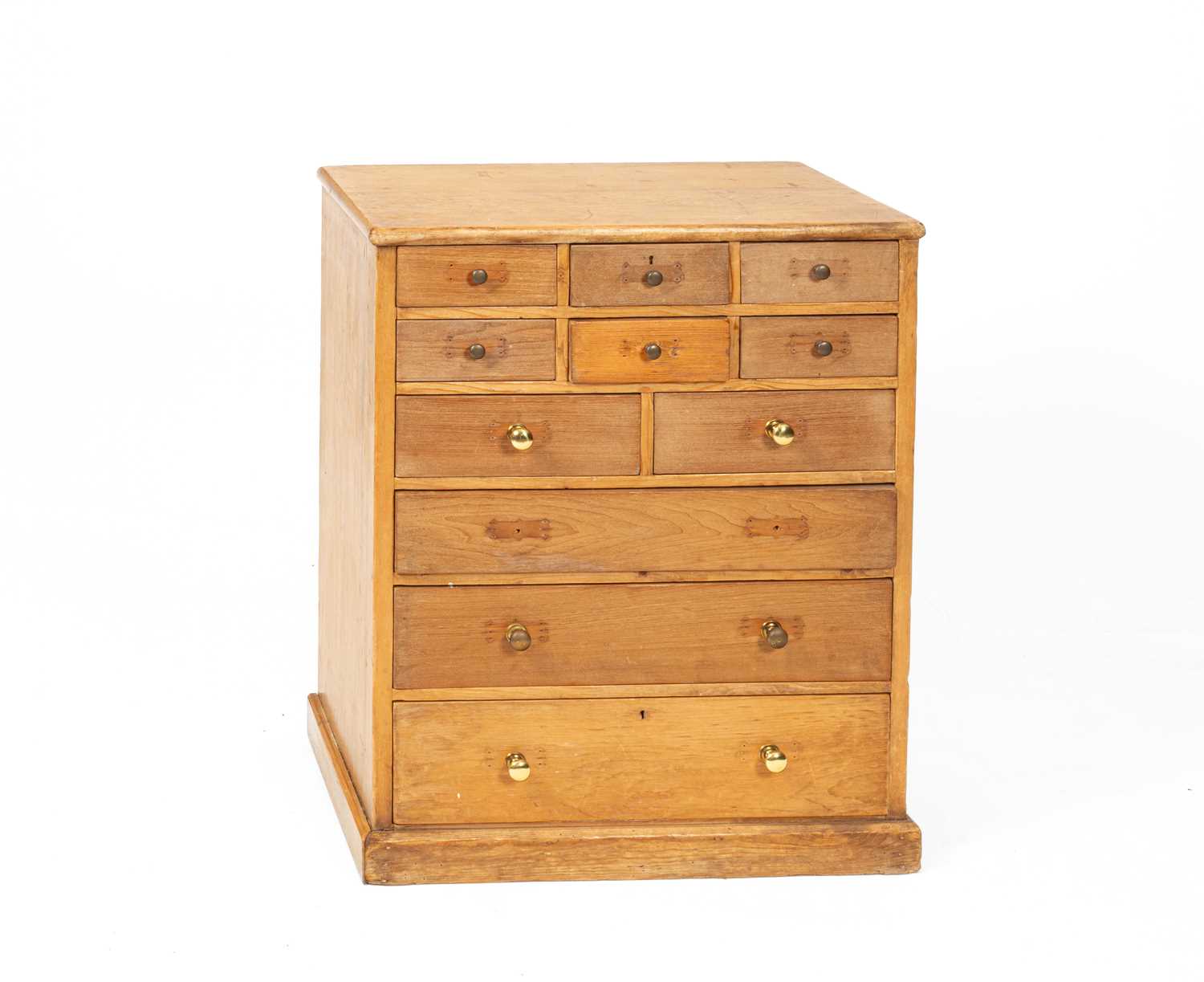 A pine bank of eleven drawers