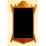 A fret carved wall mirror