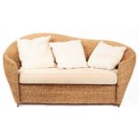 A woven rush two-seat conservatory sofa