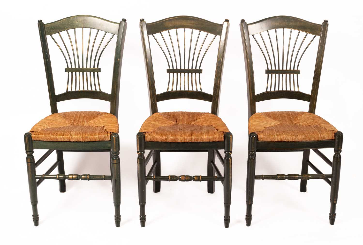 A set of three green stained kitchen chairs