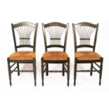 A set of three green stained kitchen chairs