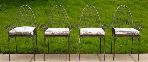 A set of four iron garden chairs of Gothic style