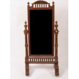 An Arts & Crafts style grained mahogany cheval mirror