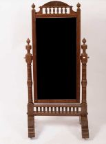An Arts & Crafts style grained mahogany cheval mirror