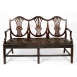 A George III style mahogany triple chair back settee