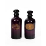 A pair of 19th Century amethyst glass apothecary’s bottles and stoppers