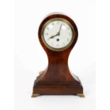 A mahogany balloon mantel timepiece