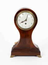 A mahogany balloon mantel timepiece