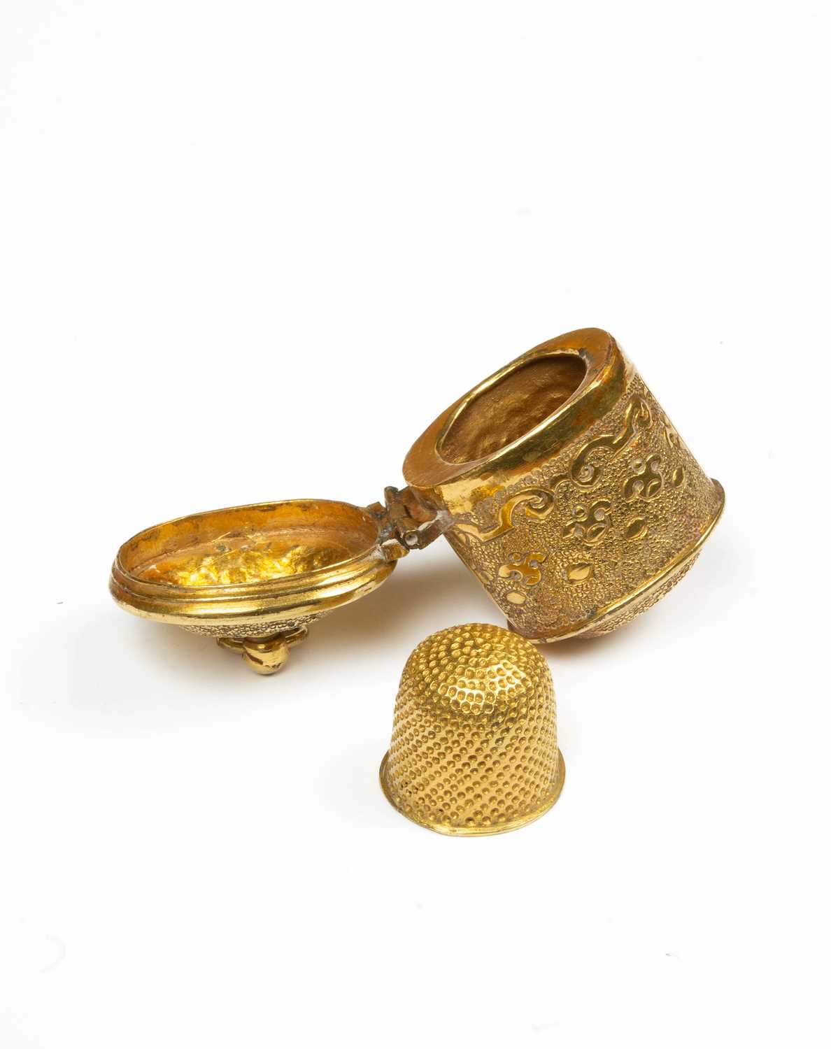 A gilt metal thimble case and thimble for a chatelaine,