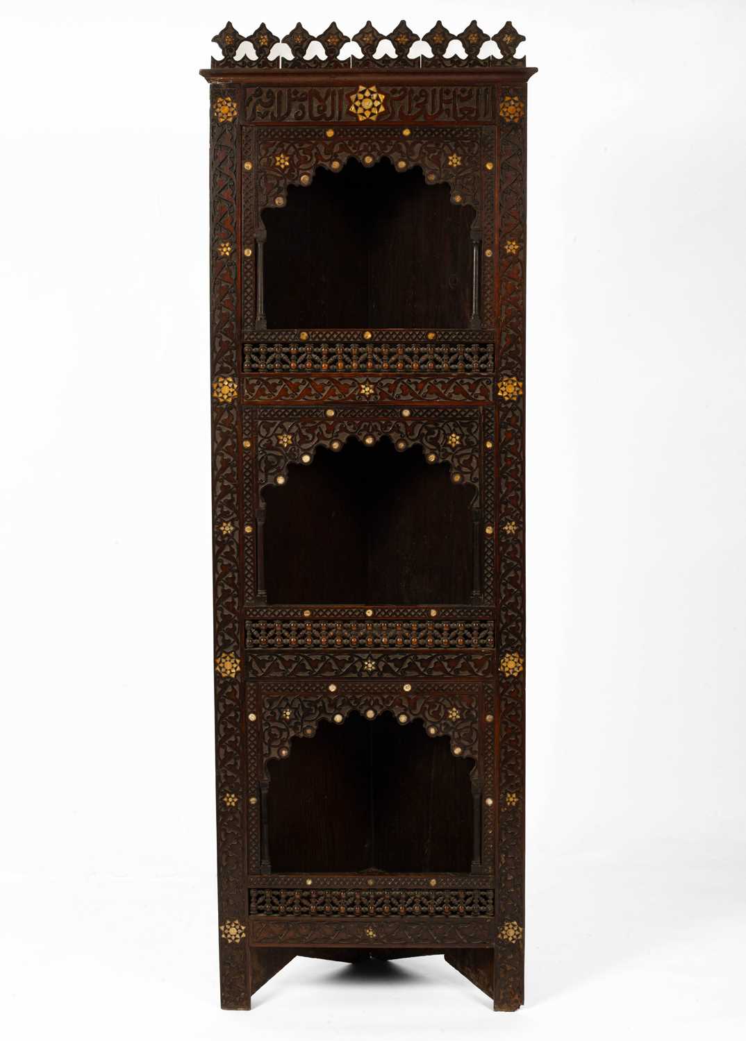 A North African carved corner cupboard