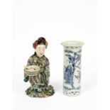 A Japanese figure of a kneeling woman holding a bowl and cover