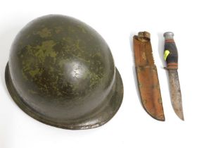 A US M1 marine WW2 military helmet twinned with a
