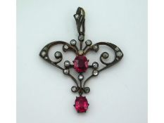 A yellow metal Edwardian pendant set with diamond & ruby which each measure 6.5mm x 5mm, 44mm drop,