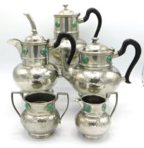 A five piece Ashberry Arts & Crafts hammered pewter tea & coffee set with Ruskin roundels, largest p