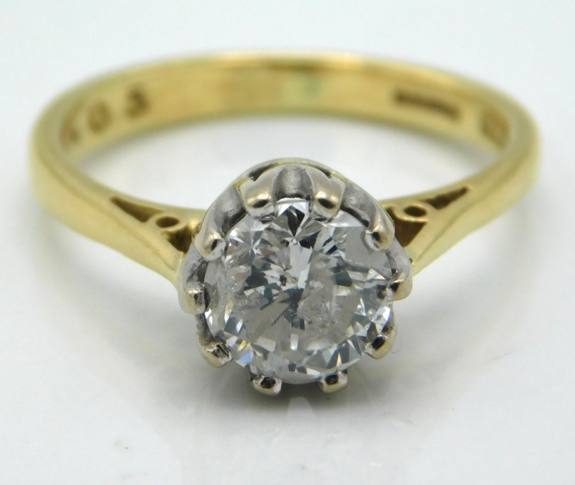 An 18ct gold solitaire ring with Tiffany style platinum mounted diamond of 1.05ct & J colour, size J