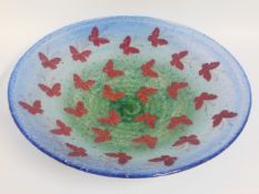 A large art glass dish decorated with butterflies,