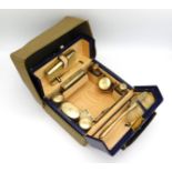 An Edwardian fitted vanity case by Edwards & Sons. The case is in blue leather with silk lining with