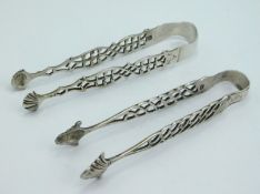 A pair of Georgian London silver sugar tongs by Robert William Jay twinned with one other pair of Ge