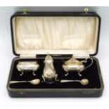 A cased 1956 Birmingham silver cruet set by Henry Clifford Davis, one later replacement spoon, 220mm