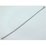 An 18ct gold diamond line bracelet of approx. 3ct,