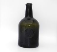 An 18thC. glass seal bottle, J. Braddon of Bridger