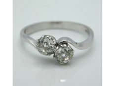 An 18ct white gold crossover ring set with two old